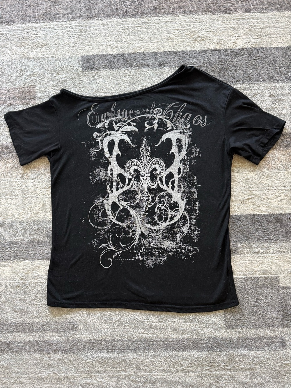 Black Off Shoulder Graphic Tee with 'Embrace the Chaos' Script